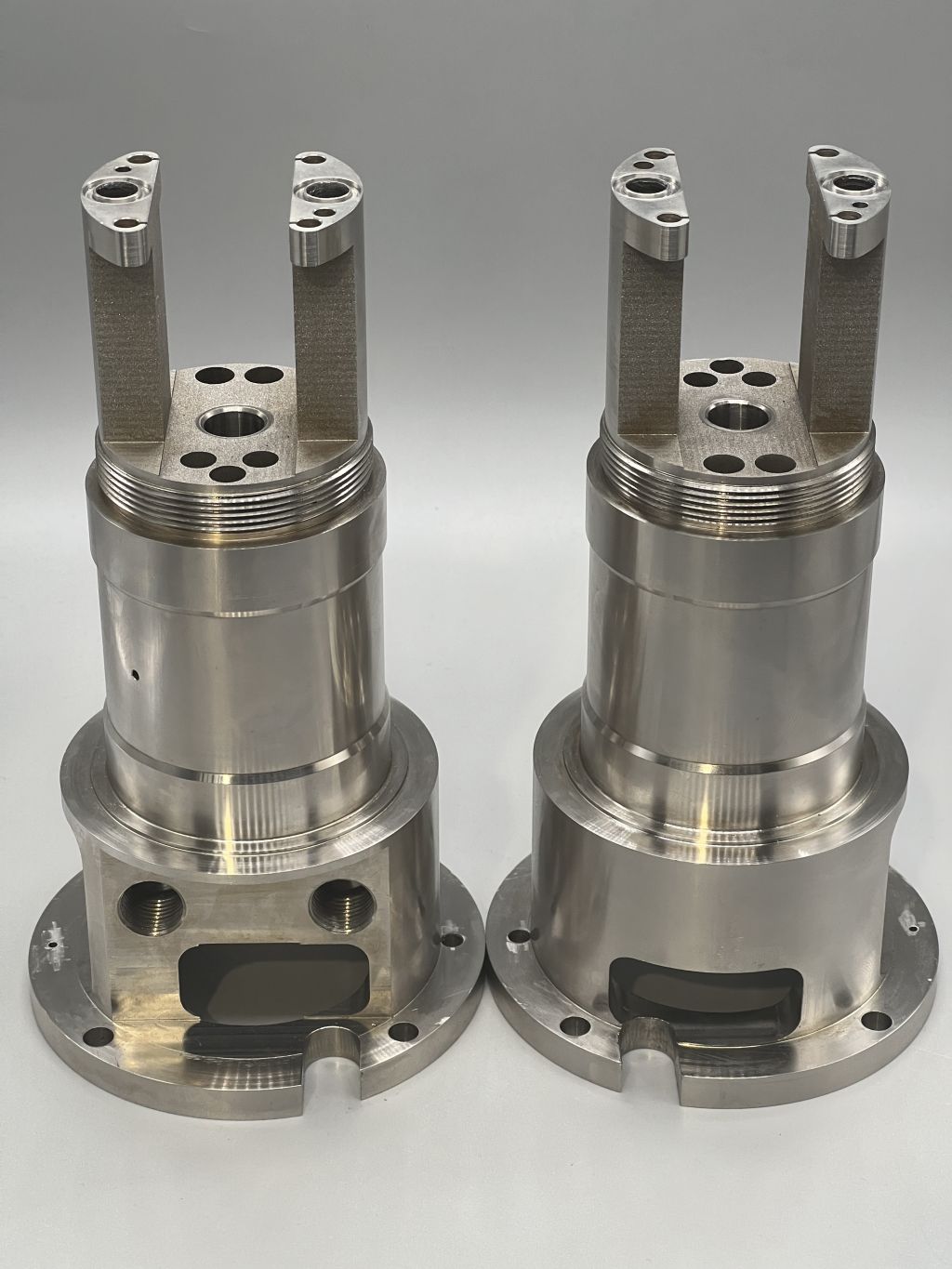 "Two precision-manufactured hydraulic components made of metal"